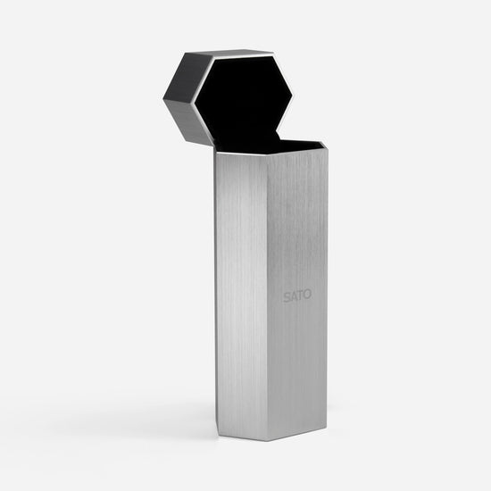 Metallic device with hexagonal top on a white background