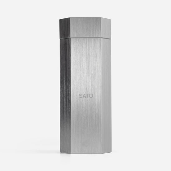 Hexagonal metallic box with 'SATO' branding on a white background