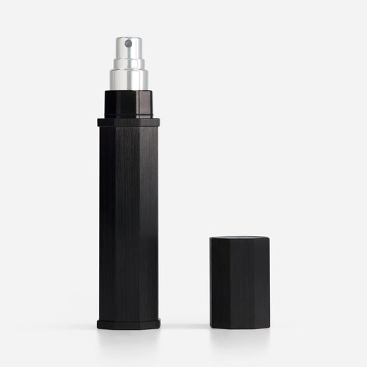 Black spray bottle with silver nozzle on a white background