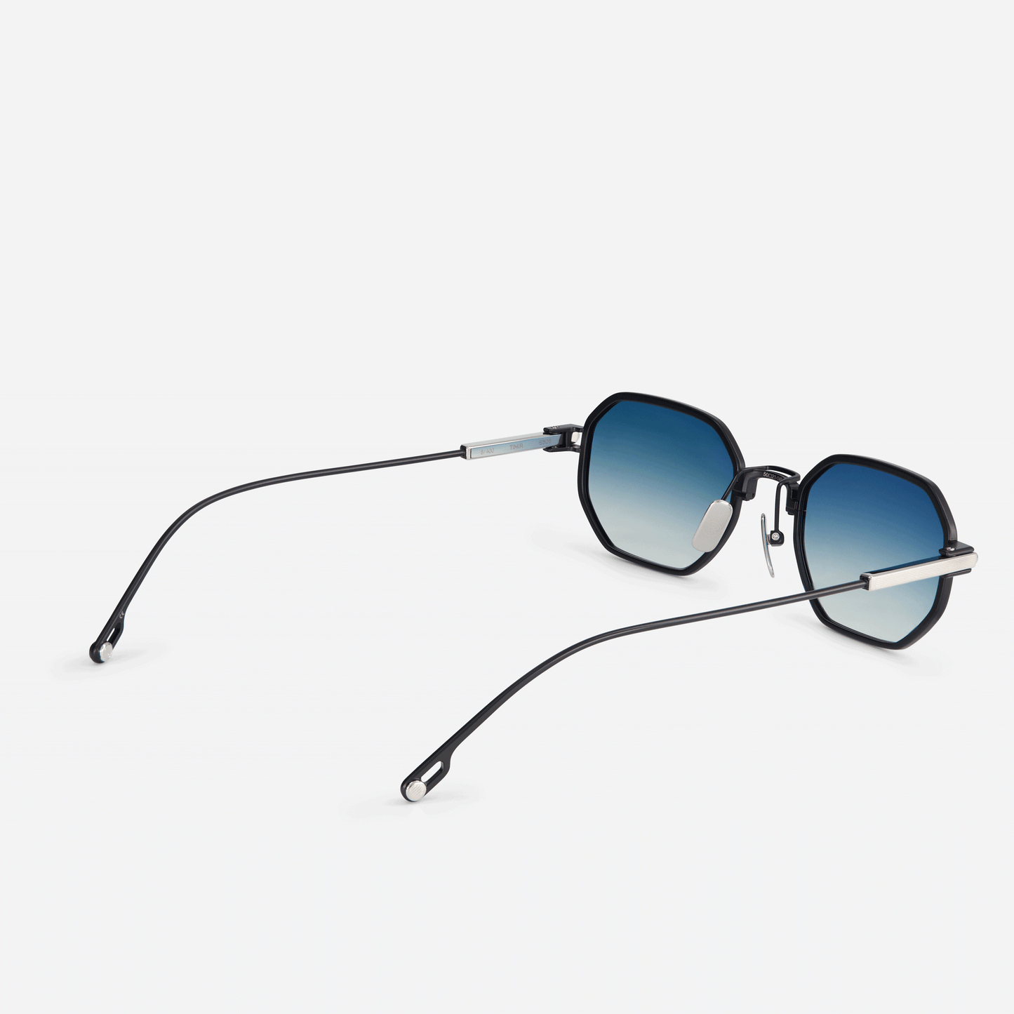 Timir S505 hexagonal glasses. Crafted from pure black titanium, these eyewear pieces feature trendy blue gradient tinted lenses, making them a perfect choice for fashion-forward men and women looking to make a statement. SATO 